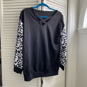 Brand new black front criss cross long sleeve with white leopard sleeves.